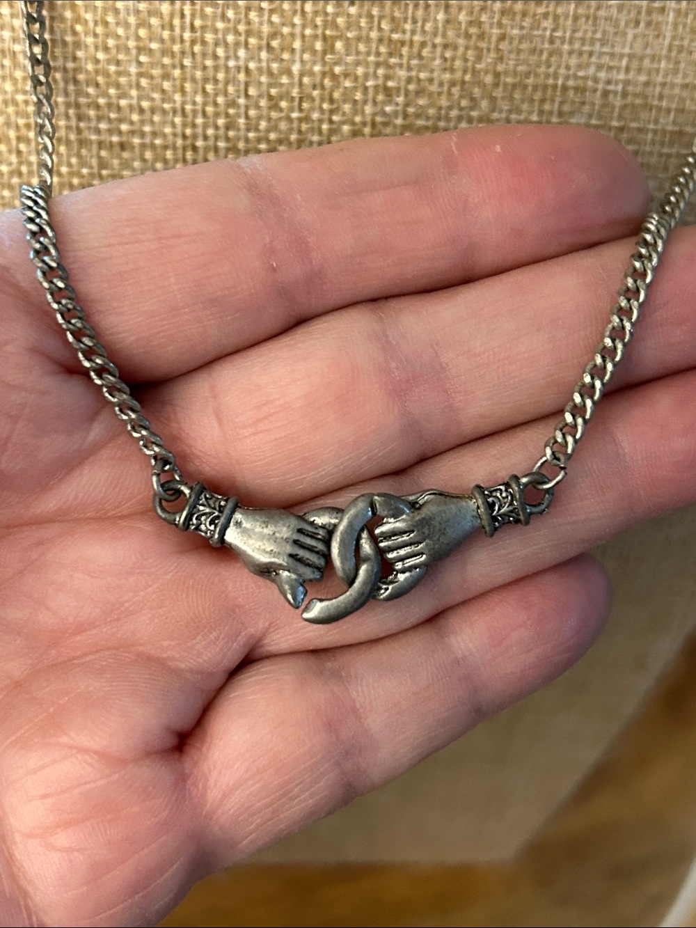 Clasped hands necklace silvertone with adjustable chain and signed tag